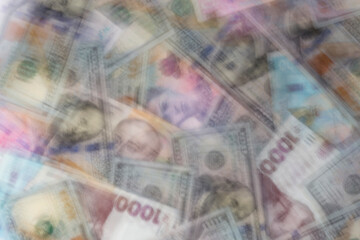 blur of heap of dollars and hrivnya banknotes