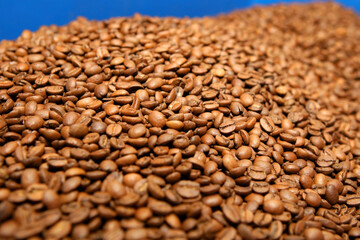 Innovative coffee roaster. The coffee is roasted using high technology in a production machine. Lots of coffee in the vat.