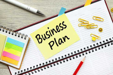 BUSINESS PLAN inscription on a yellow sticker. on the diary