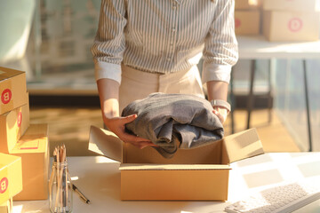 Close-up of an online business owner woman check customer lists to properly pack and ship to customers.