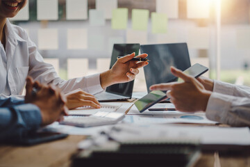 Business people meeting to find analytical ideas pointing to the graph at the office.