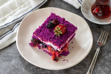 Fruit cake slice. Forest fruit cake on a dark background. Bakery products. side view. Close-up.