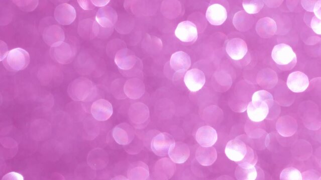 Magic glowing bokeh in pink color. Abstract blurred glitter background