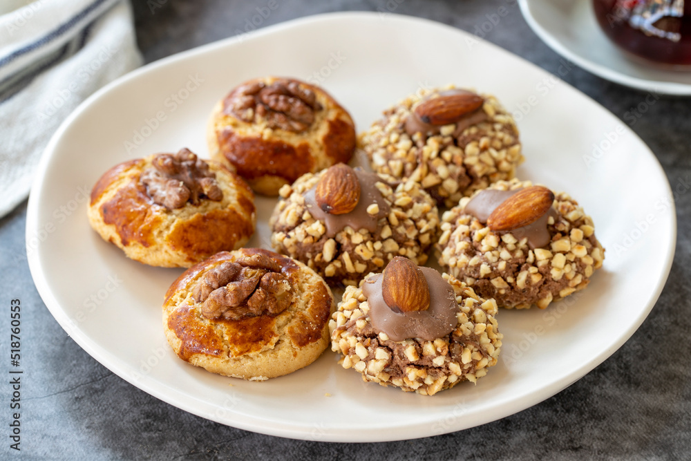 Wall mural almond and walnut cookies. assortment of sweet cookies on dark background. bakery products. side vie