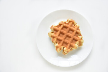 Viennese waffles on a white plate. Delicious waffles for breakfast.