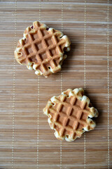 Viennese waffles on a mat. Sweet cookies for breakfast.