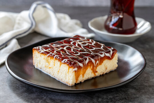 Trilece dessert. Slice of dessert with caramel and milk on a dark background. Bakery products. side view. Close-up.