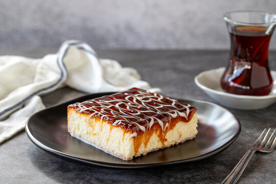 Trilece dessert. Slice of dessert with caramel and milk on a dark background. Bakery products. side view. Close-up.