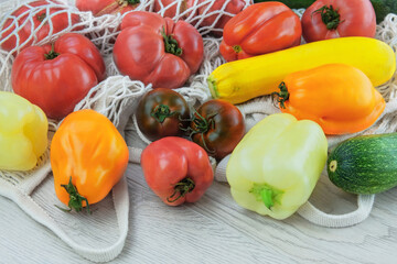 Set of farming tomatoes, peppers, zucchini in cotton bag. Zero waste shopping. Peasant style.