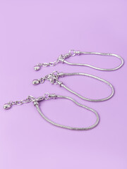 Three bases for bracelets on lilac background. Creating jewelry