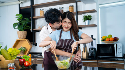 asian couple cooking at kitchen