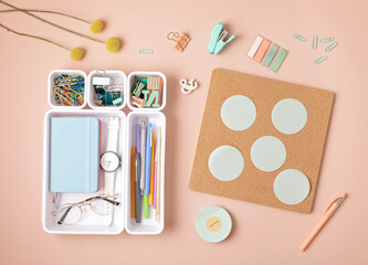 Desktop organization. Plastic organizers for office and home desk and cork board with sticker notes...