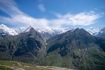 Mt.Hanuman tibba, friendship peak and seven sister peaks seen enroute Rohtang Pass,Manali in Himachal pradesh. Amazing view of snow covered high altitude mountain peaks. Blue sky with clouds landscape