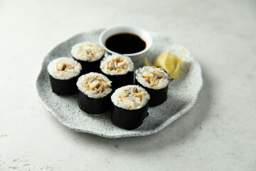 Eel sushi with soy sauce and ginger