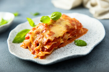 Traditional homemade lasagna with fresh basil