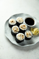Eel sushi with soy sauce and ginger