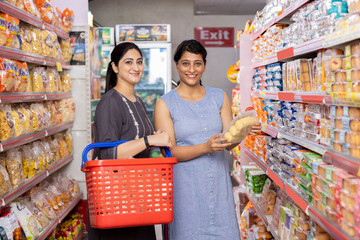 Two women  shopping at supermarket