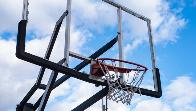 Broken Glass Backboard And Broken Hoop On The Basketball Court