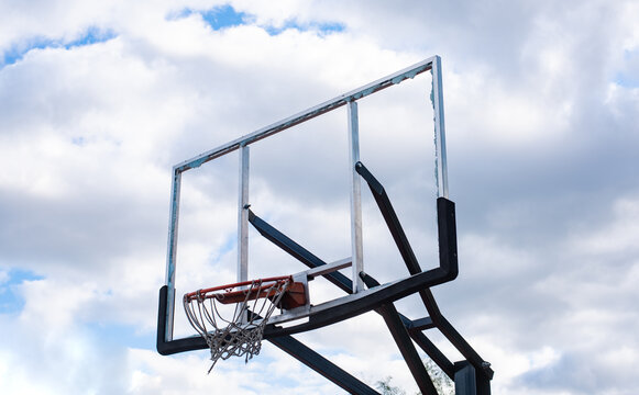 Broken glass backboard and broken hoop on the basketball court