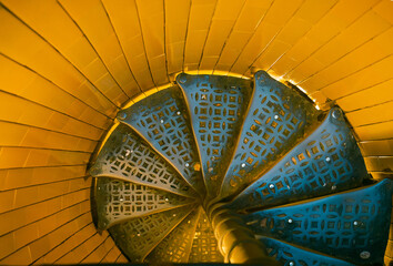 details of a metal golden spiral staircase 