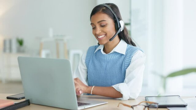 Call center agent talking to clients while wearing a headset and answering their questions while typing on a laptop online. Helpline worker giving advice to people and helping them with problems