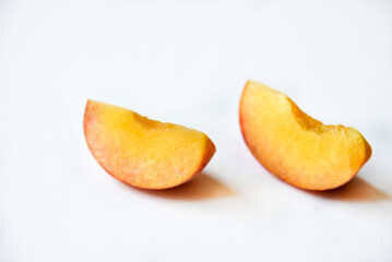 Sliced fresh peaches on a white background.