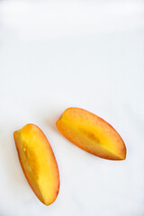 Sliced fresh peaches on a white background.