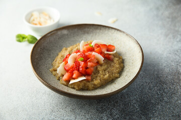 Healthy quinoa porridge with fresh strawberry