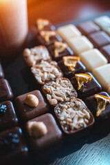 set of delicious handmade chocolate candies with coffee to go in paper cup