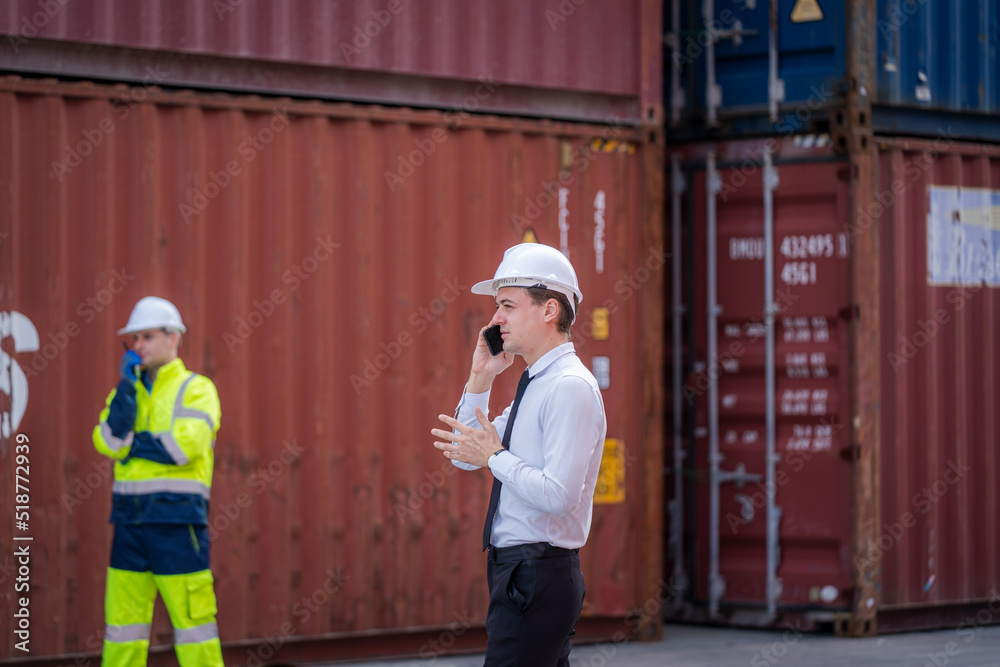 Poster businessman having discussion with the manager at container yard warehouse,manager and customer chec
