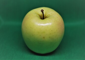 apple on a green background. Yellow apple. Healthy Eating. Diet. Organic apple