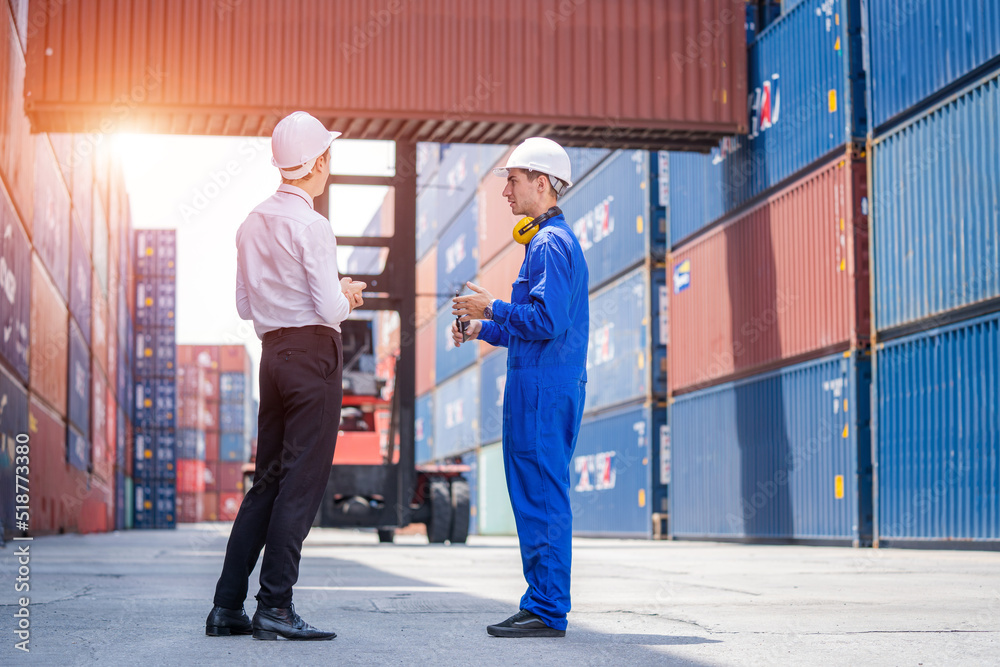 Poster Manager and Technicians planning the transportation of goods for import Or export in the container yard,Checking on shipping containers.