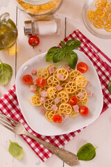 Ruote pasta with tomato and ham.
