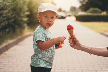Children with ice cream. Childhood concept. Boy eating ice cream in the street