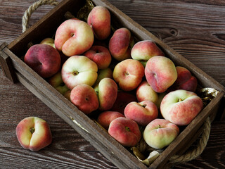 Ripe peaches in a wooden box