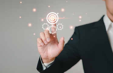 Businessman man pointing finger at target icon representing success in business, finance, teamwork.Objectives, Business investment goals and goals for business investment ideas.