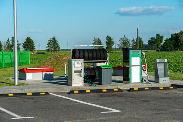 A special equipped place at the gas station for manual wheel pumping and car cleaning. Car maintenance and service.