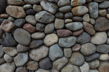 A close up view of a group of oval-shaped rocks with dark pastel colors