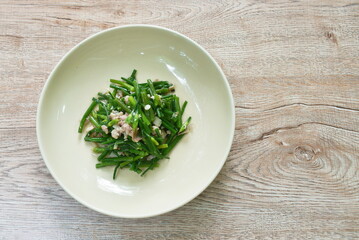 stir fried slice garlic chives with chop pork on plate