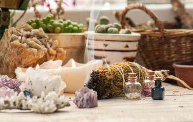 Cozy space with candles, crystals, herbs, and plants. Alternative medicine, herbal medicine,...