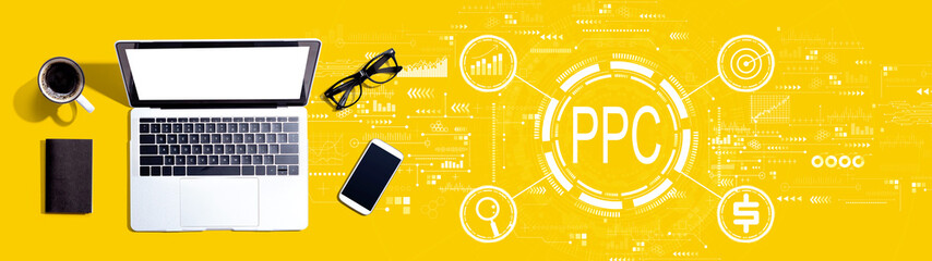 PPC - Pay per click concept with a laptop computer on a desk - obrazy, fototapety, plakaty