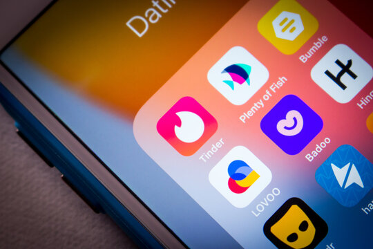 Kumamoto, JAPAN - Jun 27 2022 : Closeup Tinder and popular dating apps Plenty of Fish, Bumble app, LOVOO, Badoo, Hinge app, Grindr, Happn and Tantan on an iPhone in a dark mood.