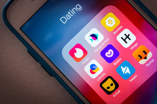 Kumamoto, JAPAN - Jun 27 2022 : Closeup Tinder and popular dating apps Plenty of Fish, Bumble app, LOVOO, Badoo, Hinge app, Grindr, Happn and Tantan on an iPhone in a dark mood.