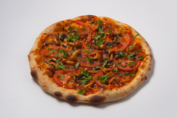 vegetarian pizza with tomatoes and mushrooms decorated with herbs