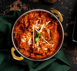 Chicken Tikka Masala served in a dish isolated on dark background top view.