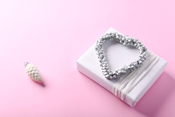 Christmas present on bright paper background. Close up. Copy space. 