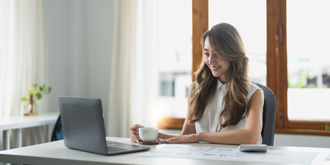 Happy asian woman sit at table busy in personal expenses management, use calculator calculate...