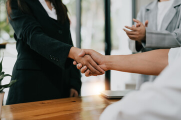 Millennial businessmen colleagues shaking hands on meeting in office, diverse enterpreneurs striking good deal, multiethnic teammates succeed in common project work