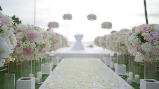 Landscape wedding reception at the beach. Wedding detail colorful flowers pattern decor beach.