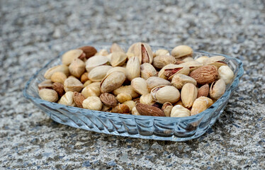 mix of various salted nuts on a glass bowl